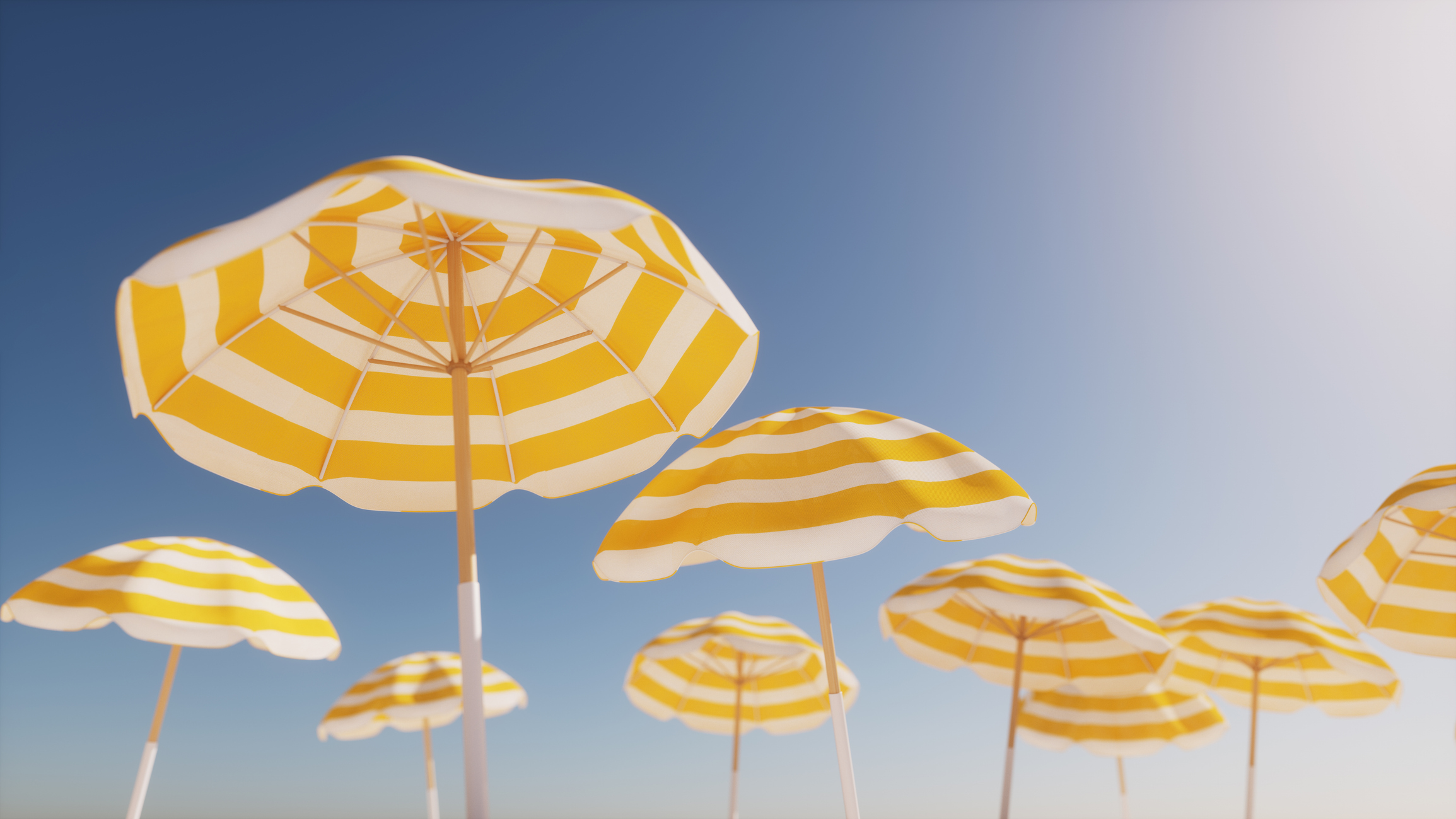 Beach umbrellas in yellow-white stripes